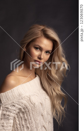 Studio photo portrait of a young pretty blonde on a dark background, close-up portrait of a woman Studio photo portrait of a young pretty blonde on a dark background, close-up portrait of a woman 123069870