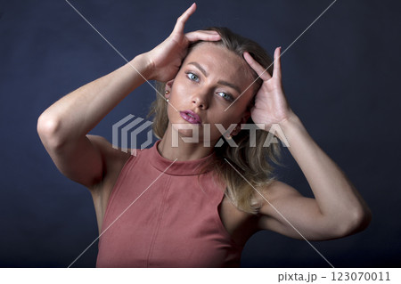 portrait of a young beautiful woman on a dark background 123070011