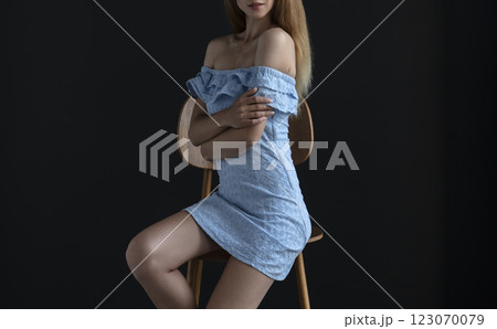 portrait of a young woman in a blue dress, full growth 123070079