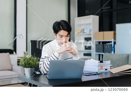 stressed asian businessman working in the office. stressed asian businessman working in the office. 123070089