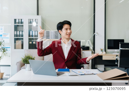 Happy young Asian man presenting or showing open hand palm, happy working. Happy young Asian man presenting or showing open hand palm, happy working. 123070095