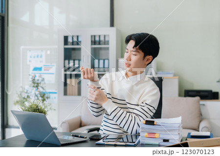 Business man have wrist pain after work hard in office. Business man have wrist pain after work hard in office. 123070123
