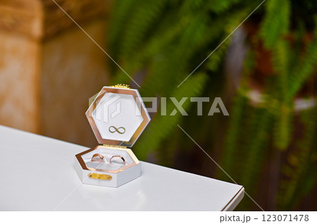 gold wedding rings in a gift box on the table 123071478