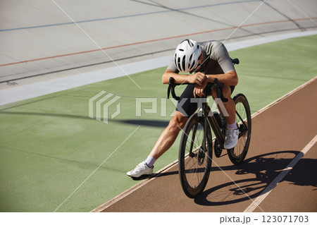 Tired exhausted bicyclist athlete stopped after hard cycling training 123071703