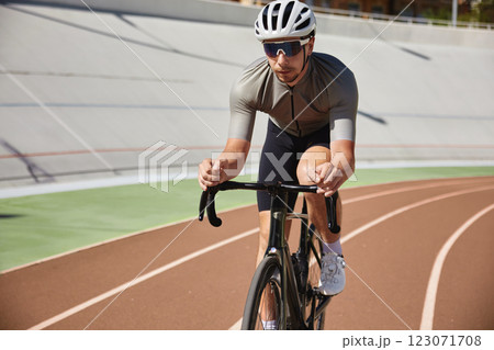Bicyclist holding hands on steering wheel driving bike Bicyclist holding hands on steering wheel driving bike 123071708