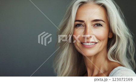 Portrait of beautiful happy smiling mature woman with toothy smile on studio background 123072169