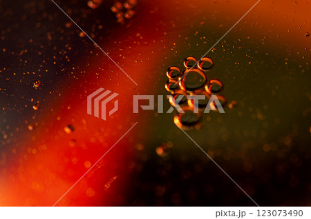 Oil in water, abstract dark background in red color tones Oil in water, abstract dark background in red color tones 123073490