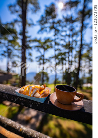 A small cup of coffee in a big forest A small cup of coffee in a big forest 123073708
