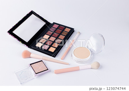 A Beautiful Array of Makeup Essentials Featuring an Eye Shadow Palette, Foundation, and Makeup Brushes for Ultimate Beauty Looks and Techniques A Beautiful Array of Makeup Essentials Featuring an Eye Shadow Palette, Foundation, and Makeup Brushes for Ultimate Beauty Looks and Techniques 123074744
