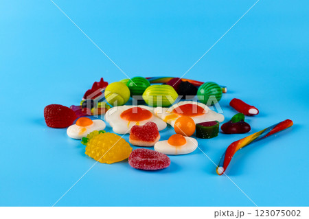 A Colorful Arrangement of Candy Imitating Various Foods Set Against a Light Blue Background for a Fun and Whimsical Treat Display Purpose in a Fascinating Way 123075002