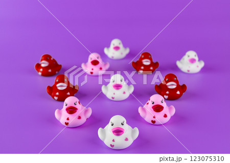 Adorable Rubber Duck Collection on Purple Background: A Fun Display of Playful Ducklings in Various Colors and Designs Bringing Joy and Whimsy to Any Setting 123075310