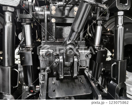 Intricate view of hydraulic system components in heavy machinery during maintenance inspection at a workshop 123075862