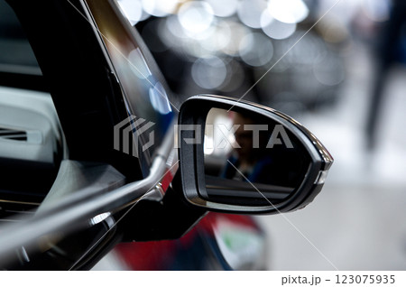 Side rear-view mirror on a modern car on blurred traffic background Side rear-view mirror on a modern car on blurred traffic background 123075935