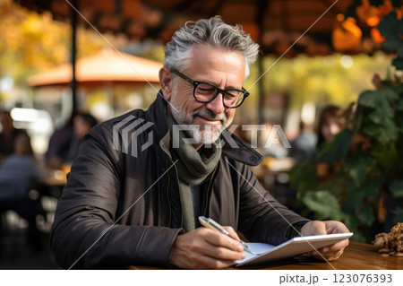 Digital Age Leisure: Elderly Man with Tablet in Cafe Setting Digital Age Leisure: Elderly Man with Tablet in Cafe Setting 123076393