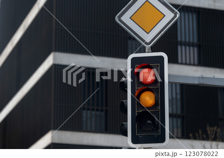 Red and yellow traffic lights on urban city background 123078022