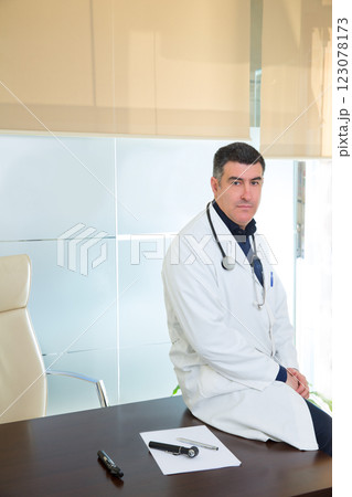Doctor man expertise portrait casual sitting in hospital office Doctor man expertise portrait casual sitting in hospital office 123078173