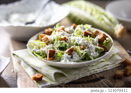 Healthy Caesar salad made with Romaine lettuce, croutons, tzatziki dressing and parmesan cheese. Healthy Caesar salad made with Romaine lettuce, croutons, tzatziki dressing and parmesan cheese. 123078411