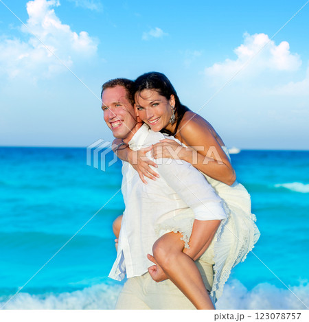 couple in love piggyback playing in beach couple in love piggyback playing in beach 123078757