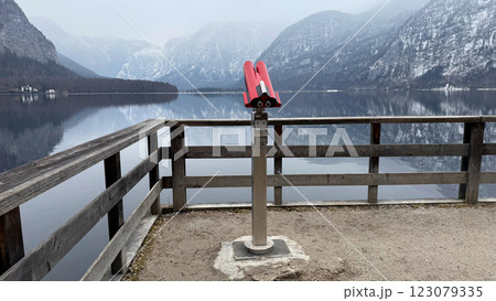 Binocular Viewer Overlooking Scenic Winter Lake Hallstatt in Austria and Snow-Covered Alpine Mountain Landscape Binocular Viewer Overlooking Scenic Winter Lake Hallstatt in Austria and Snow-Covered Alpine Mountain Landscape 123079335