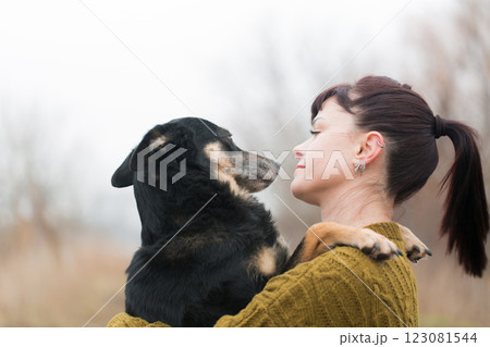 Woman and shepherd dog hugging on a walk 123081544