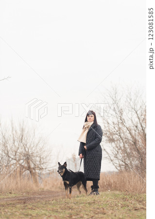 Woman walking her dog in park 123081585