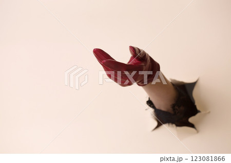 A woman's hand in a leather glove shows a gesture of request A woman's hand in a leather glove shows a gesture of request 123081866