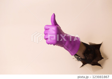 A woman's hand in a leather fuchsia glove shows a gesture good 123081867