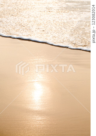 An ocean beach with calm waves. The water is clear and the sand is golden An ocean beach with calm waves. The water is clear and the sand is golden 123082014