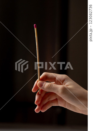 A hand holding a bunch of matches with a pink tip 123082736