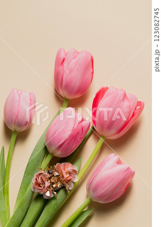 Spring still life handmade beetle brooch with pink bottom tulips, top view Spring still life handmade beetle brooch with pink bottom tulips, top view 123082745