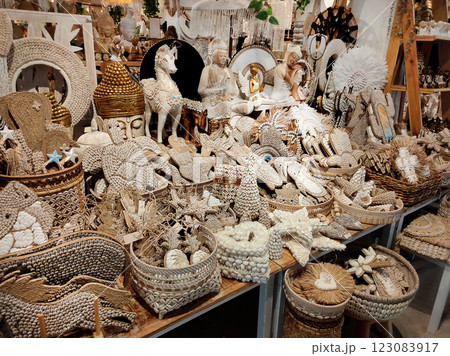 Rattan round table mats decorated with shells and rattan bottle holders at a street shop. Bali, Indonesia. Rattan round table mats decorated with shells and rattan bottle holders at a street shop. Bali, Indonesia. 123083917
