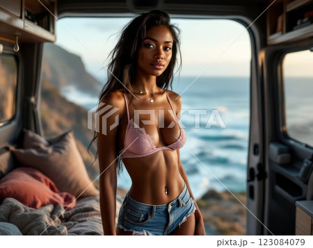 Beautiful woman posing inside a camper van by the sea 123084079