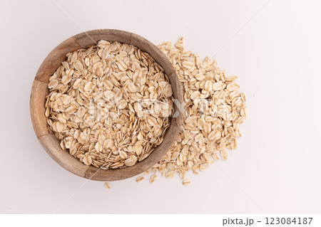 dry rolled oatmeal in bowl isolated dry rolled oatmeal in bowl isolated 123084187
