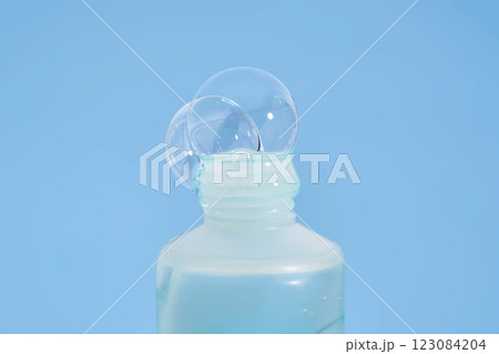 Shampoo pouring out of a small tube on a blue background. Texture. 123084204