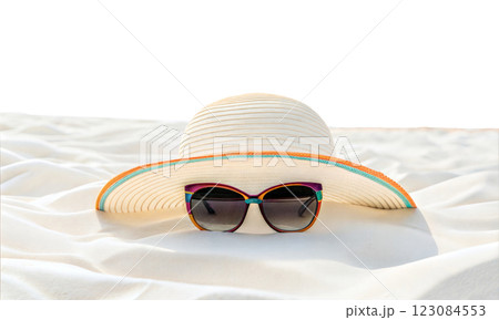 A hat and sunglasses are on the beach, likely left by a sunbather 123084553