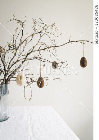 Easter paper eggs hanging on branches. Easter decor. Easter paper eggs hanging on branches. Easter decor. 123085426