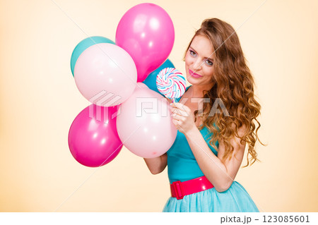 Woman with colorful balloons and lollipop 123085601