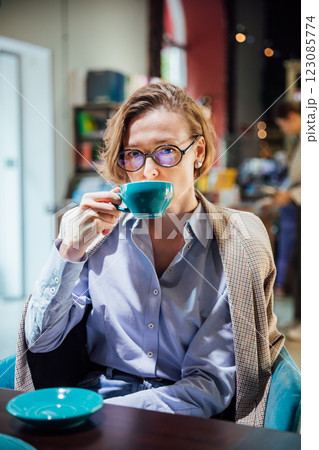 woman drinking coffee tea in book restaurant woman drinking coffee tea in book restaurant 123085774