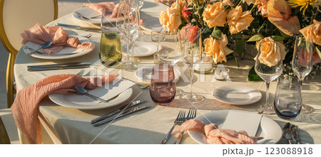 Banner Wedding banquet concept. Chairs and round table for guests, served with cutler and, flowers and crockery and covered with a tablecloth Banner Wedding banquet concept. Chairs and round table for guests, served with cutler and, flowers and crockery and covered with a tablecloth 123088918