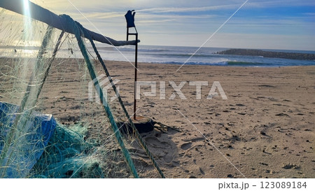 Fishing equipment, boats, nets on the Atlantic coast in Portugal. Fishing trash on the ocean beach. Fishing equipment, boats, nets on the Atlantic coast in Portugal. Fishing trash on the ocean beach. 123089184