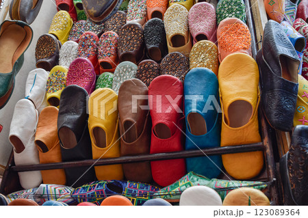 Slippers or sandals of many colors hung from street stalls in Marrakech's souk Slippers or sandals of many colors hung from street stalls in Marrakech's souk 123089364