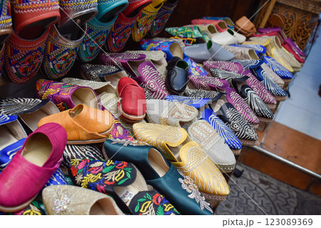 Slippers or sandals of many colors hung from street stalls in Marrakech's souk 123089369