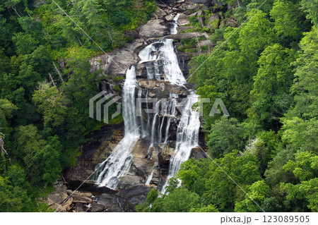 Whitewater Falls with falling down clear water from rocky boulders between green lush woods in Nantahala National Forest, North Carolina, USA 123089505