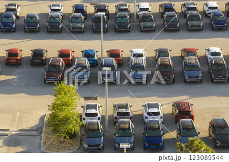 View from above of dealers outdoor parking lot with many brand new cars in stock for sale. Concept of development of american automotive industry View from above of dealers outdoor parking lot with many brand new cars in stock for sale. Concept of development of american automotive industry 123089544