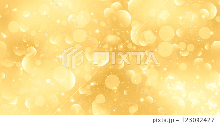 幻想的な光の粒が散りばめられた金色のグリッター素材 123092427
