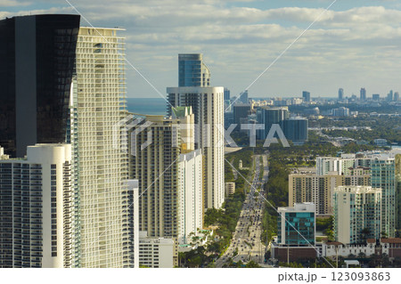Sunny Isles Beach city with luxurious highrise hotels and condo buildings and busy ocean drive on Atlantic coast. American tourism infrastructure in southern Florida Sunny Isles Beach city with luxurious highrise hotels and condo buildings and busy ocean drive on Atlantic coast. American tourism infrastructure in southern Florida 123093863