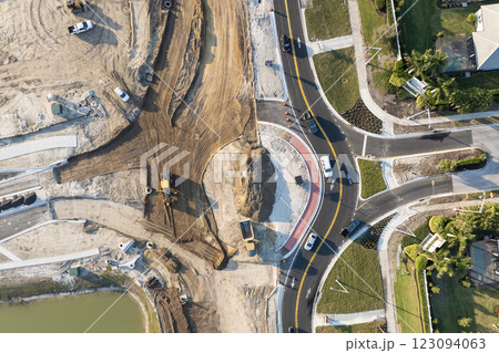 Roadworks construction site at roundabout intersection on American highway. Development of city circular transportation crossroads 123094063