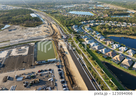Roadworks construction site at roundabout intersection on American highway. Development of city circular transportation crossroads 123094066