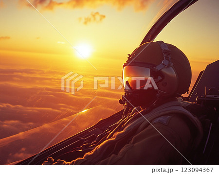 A pilot in a fighter jet cockpit flies above the clouds during a vibrant sunset, with the sun casting a golden glow on the aircraft and the sky. 123094367