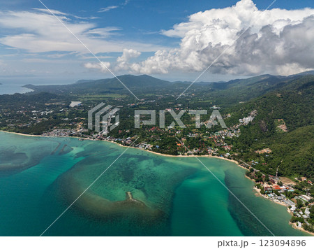 Serene beach with white sand and surrounding greenery extending into the ocean with vibrant tropical colors. Koh Samui, Thailand. 123094896